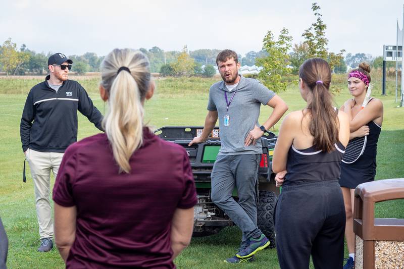 Woodstock North tennis coach Bart Zadlo talks with his team during the 2021 fall season.