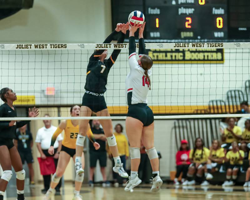 Joliet West's Gabby Piazza (7) blocks a shot then tips it over the net for a point during regional final volleyball match between Bolingbrook at Joliet West.  Oct 26, 2023.