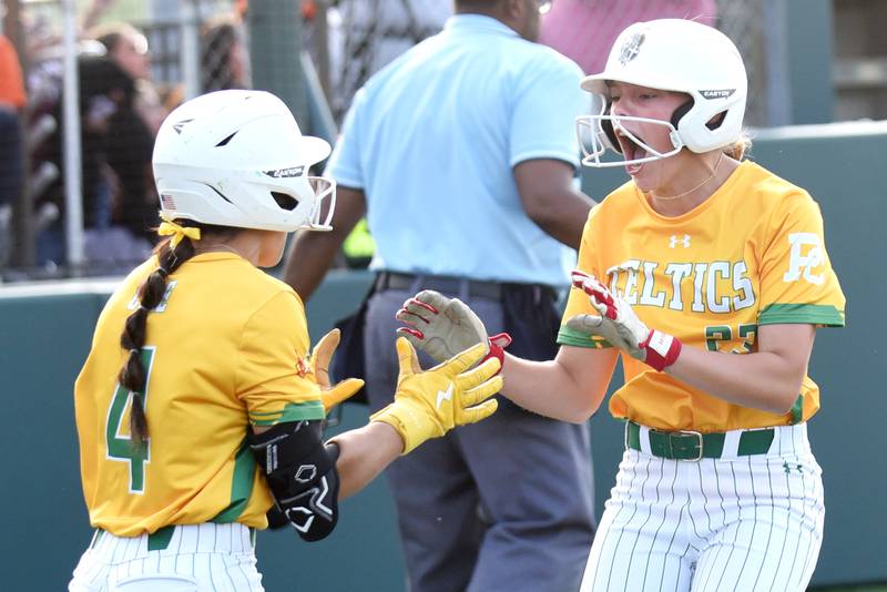 Providence's Reagan Singler, right, celebrates with Angelina Cole after scoring the winning run in the Celtics' 5-4 win in nine innings over Pontiac in the Class 3A Illinois Wesleyan Supersectional Monday, June 9, 2025.