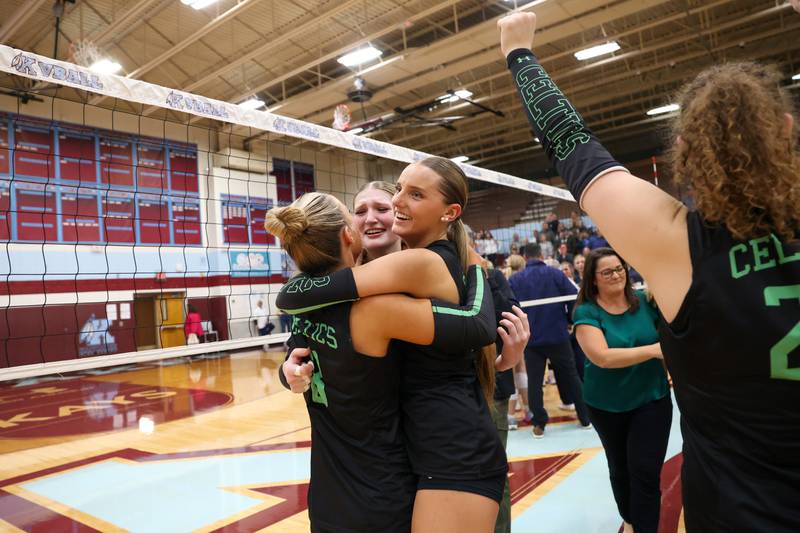 Providence's Abbey Knight, center, hugs Cali Tierney, right, and Demi Carbone following the Celtics' victory in two sets, 25-25, 25-18, over Lemont in the IHSA Class 3A Kankakee Sectional championship on Thursday, Nov. 6, 2025.
