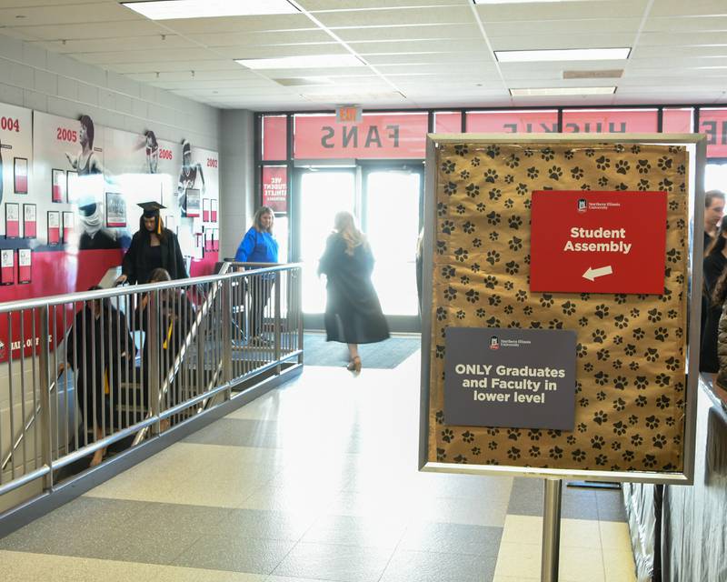 A sign points the way for the Northern Illinois University graduates where to go before the commencement ceremony on Saturday May 9, 2026, held at the Convocation Center in DeKalb.