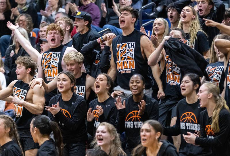 Wheaton Warrenville South fans cheer on their team during a game between Wheaton North and Wheaton Warrenville South on Friday, Dec. 20, 2024.