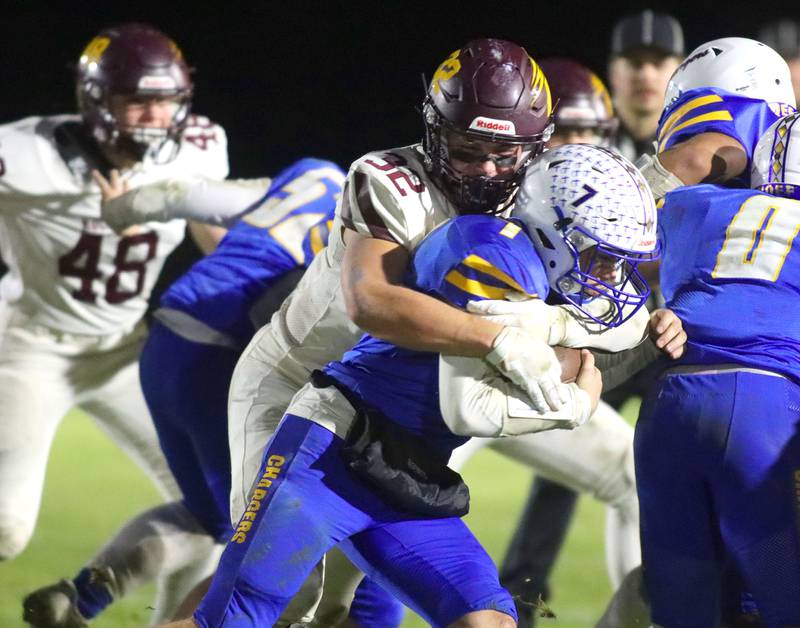 Richmond-Burton’s  Breckin Campbell wraps up Aurora Central Catholic quarterback Grant Bohr in IHSA football Class 3A second-round playoff action at Bob Stewart Field on the campus of Aurora Central Catholic High School in Aurora on Friday, November 7, 2025.