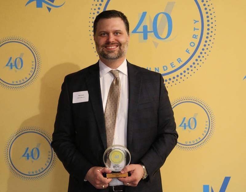 Tim Gatza poses for a photo with his award during the 40 Under Forty awards banquet on Thursday, March 21, 2024 at Westclox in Peru.