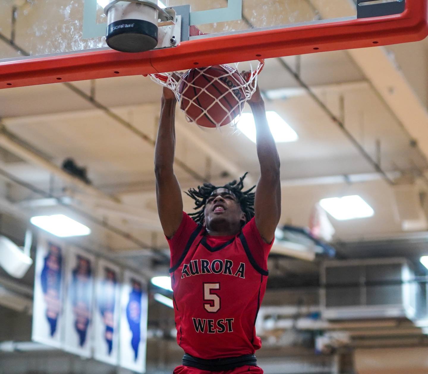 West Aurora's Terrence Smith (5) dunks the ball against Oswego during a basketball game at Oswego High School on Friday, Dec 1, 2023.