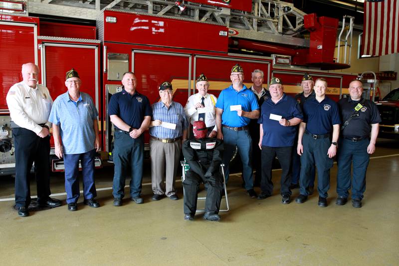 (Left to right) St. Charles Fire Chief Scott Swanson, Mike Foulkes of the St. Charles Veteran Center, Lt. Steve Dries, VVA Chapter 693 President Stanley Herzog, American Legion Post 342 Commander Joe Morgan, Sr., VFW Post 5036 Commander Jack Erwin, Deputy Chief Tony Cavallo, John DePauw, veteran and former firefighter, VFW Post 5036 Vice Commander Jake Wyatt, Jr., Firefighter Andrew Kidd and Firefighter Brian Hansen gather with the donations collected by the VFW, American Legion, AMVETS and Vietnam Veterans of America. The donations were used by the St. Charles Fire Department for a training mannequin.