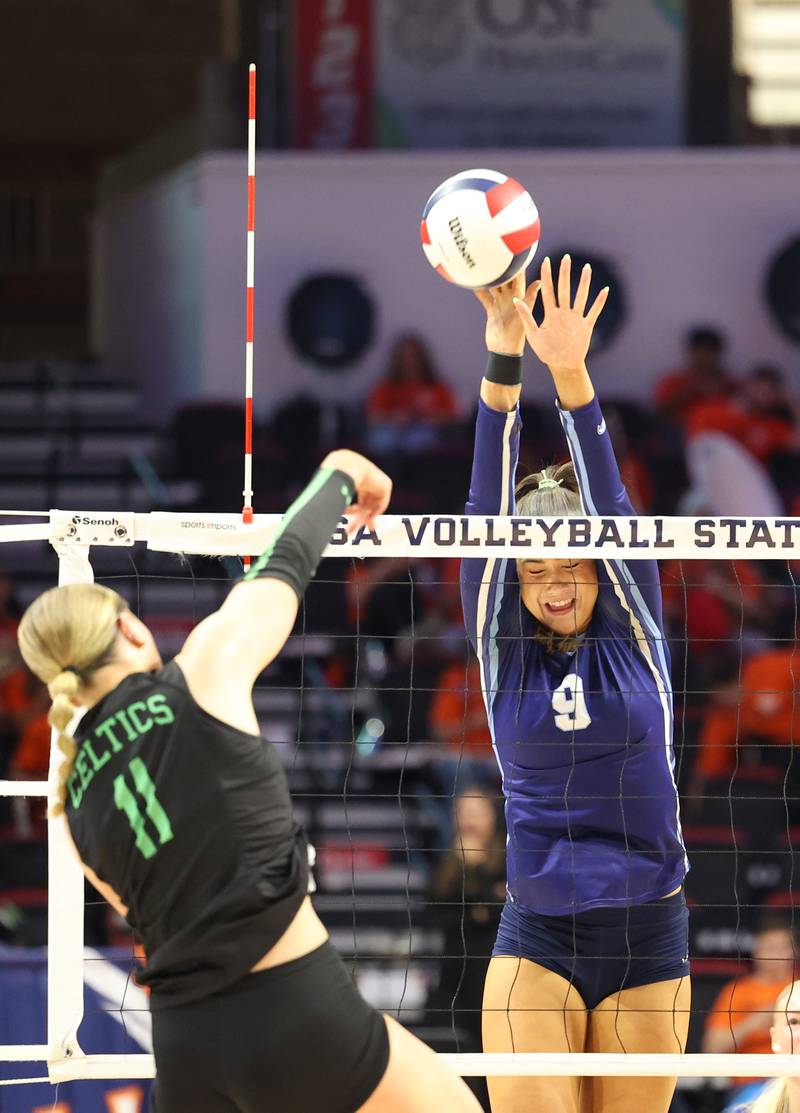 Nazareth's Jane Manecke, center, blocks a hit by Providence's Abbey Knight during Nazareth's victory in two sets, 25-16, 25-17, over Providence in the IHSA Class 3A State semifinals on Friday, Nov. 14, 2025.