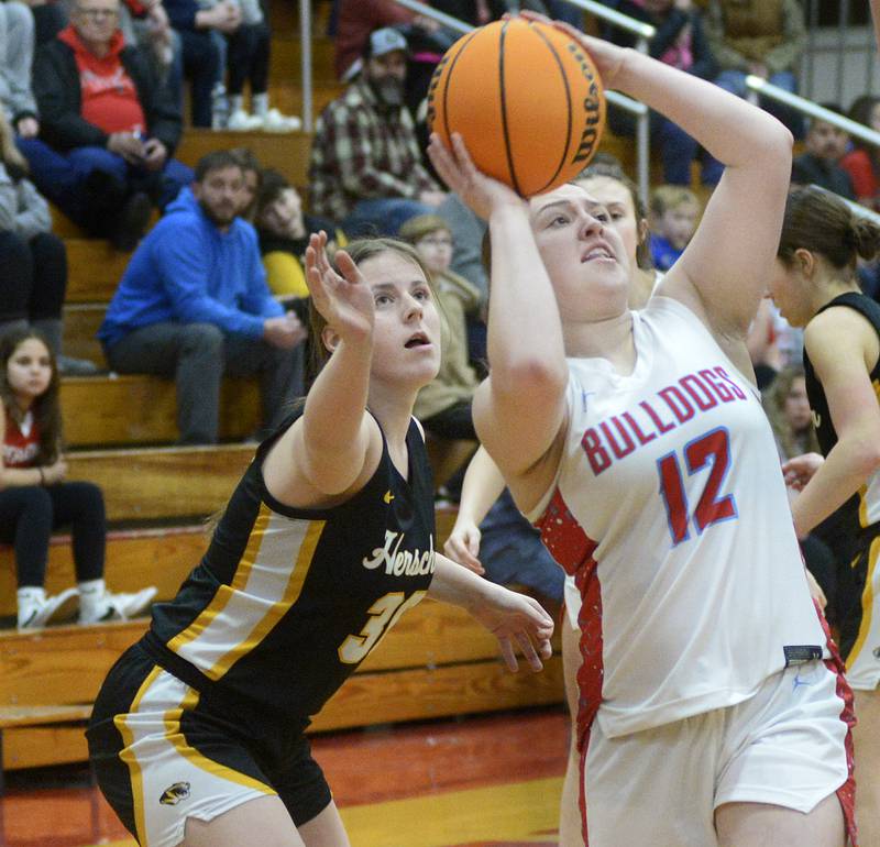 Streator's Leah Krohe (12) gets past Herscher’s Pippa Dunhill (30) for a first-quarter shot Thursday, Jan. 16, 2025, at Pops Dale Gymnasium in Streator.