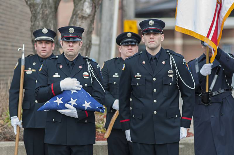 A flag bearer stands at attention as the remains of Capt. Garrett Ramos arrives at the Sterling Fire Department. There was a ceremony in which the flag was presented to the Ramos family