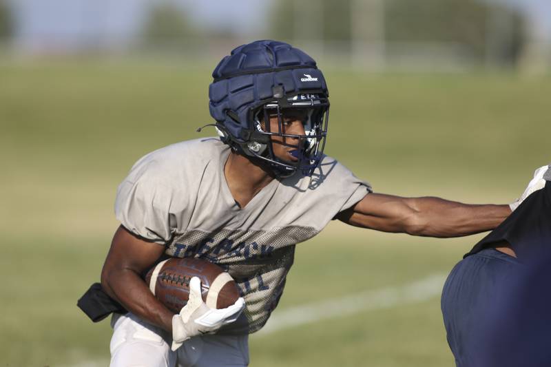 Jasiah Watson follows his blocker at Oswego East High School football practice, Monday, Aug 13, 2025 in Oswego.