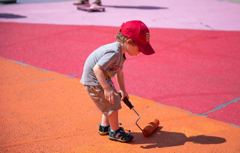 Richard Mahon, 2, of St. Charles paints the intersection of Riverside Avenue and Walnut Street in St. Charles at the Paint the Riverside event hosted by the St. Charles Arts Council on Saturday, July 30, 2022.