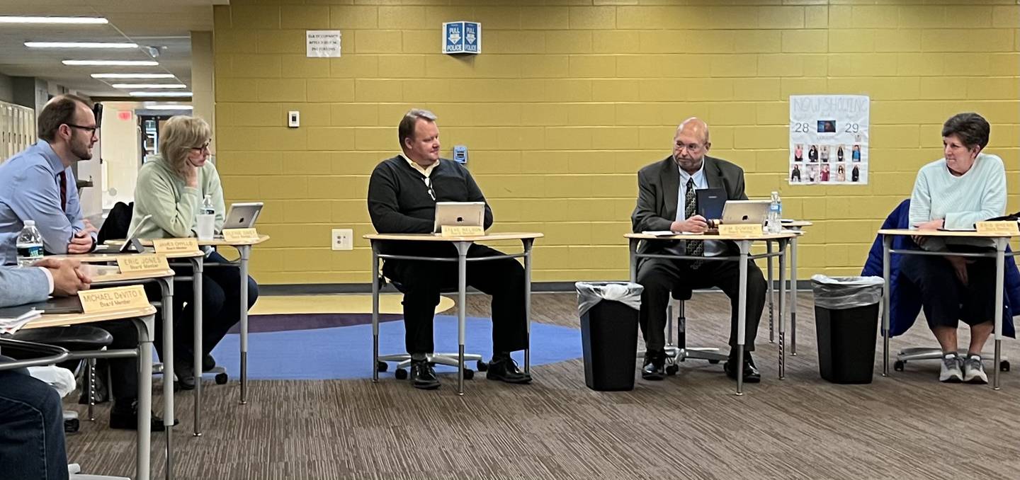 Members of Sycamore Community School District 427 Board of Education look at each on April 25, 2023, during the final meeting for Steve Nelson, Kris Wrenn and Julenne Davey. From left to right: James Chyllo, Davey, Nelson, Board President Jim Dombek and Wrenn.
