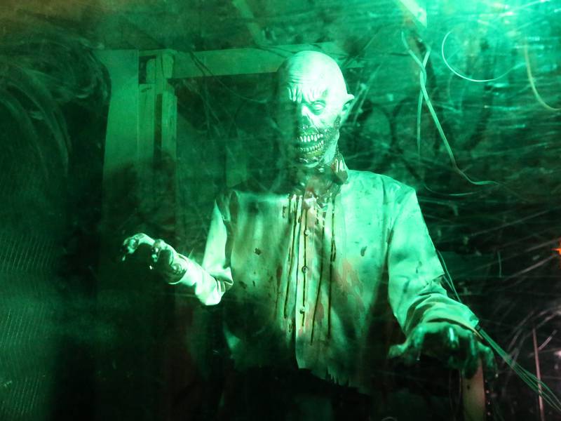 A zombie character illuminates through a green light during the Nightmare Haunted Attraction on Saturday, Oct. 14, 2023 at the Bureau County Fairgrounds in Princeton.