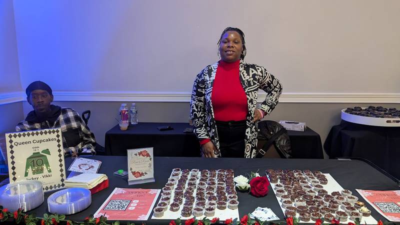 Vikki Brown of Joliet poses behind her Queen Cupcakes table at the Shorewood HUGS annual chocolate ball on Saturday, February 1, 2025, in Joliet.