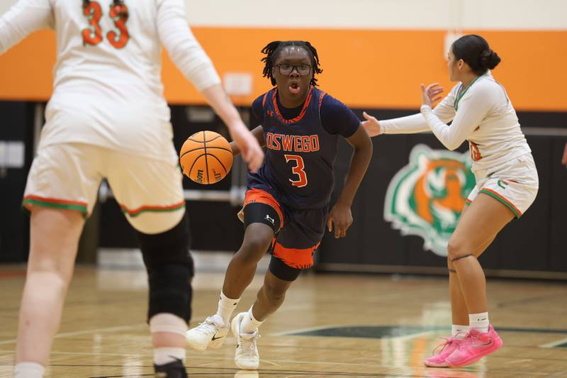 Oswego’s Madelyn-Jordyn Mensah drives to the paint against Plainfield East on Tuesday, Jan. 13, 2026 in Plainfield.