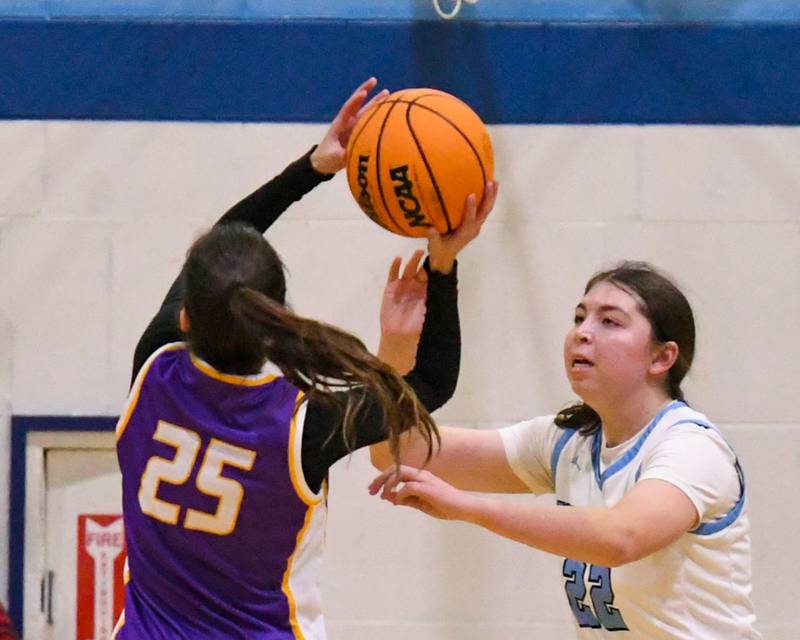 Downers Grove North's Caitlin Sandrige (25) makes a shot while being defended by Downers Grove South's Katelyn Konieczka (22) during the game on Saturday Dec. 21, 2024, held at Downers Grove South High School.
