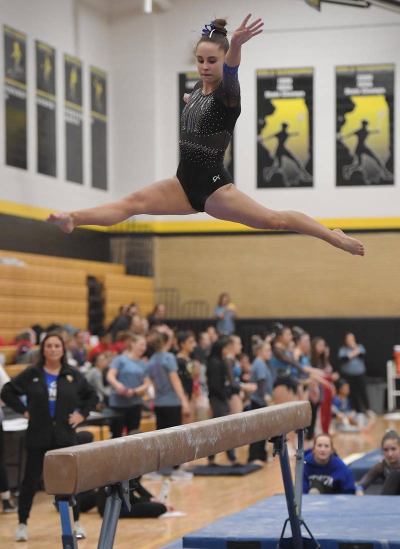 Geneva's Reese Lackey on the balance beam at the Hinsdale South girls gymnastics sectional meet in Darien on Tuesday, February 7, 2023.