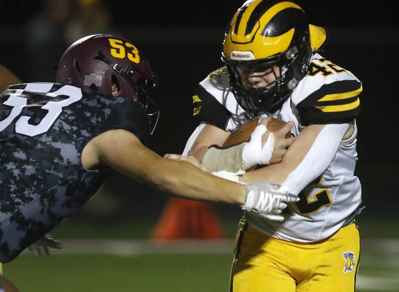 Richmond-Burton's Logan Garcia tackles Harvard's Blake Livdahl during a Kishwaukee River Conference football game on Thursday, Oct.12, 2023, at Richmond-Burton High School.