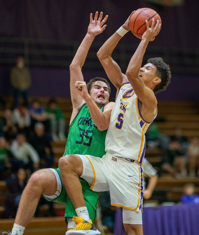 Downers Grove North's Jacob Bozeman (5) drives to the hoop against York's Braden Richardson (35) during a basketball game at Downers Grove North High School on Friday, Dec 9, 2022.
