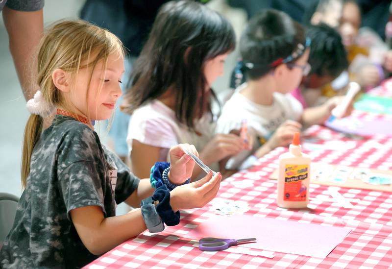 Keera Bengford-Breneisen (left) 9, from DeKalb, along with other participants do an art project Monday, July 11, 2022, during of a session of Summer Reading Vacation put on by Neighbors' House in DeKalb in conjunction with the DeKalb County Farm Bureau. Christ Community Church is hosting the camp this week in their outreach center on North 6th Street in DeKalb.