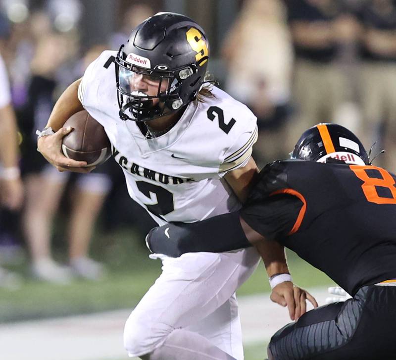 Sycamore's Elijah Meier tries to break the tackle of DeKalb's Armani Blanton during the First National Challenge Friday, Aug. 26, 2022, in Huskie Stadium at Northern Illinois University in DeKalb.