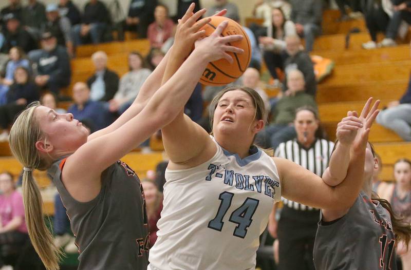 Flanagan-Cornell/Woodland's Kora Edens grabs a rebound over Cissna Park's Autum Reutter during the Class 1A Sectional semifinal game on Tuesday, Feb. 25, 2025 at Midland HIgh School.