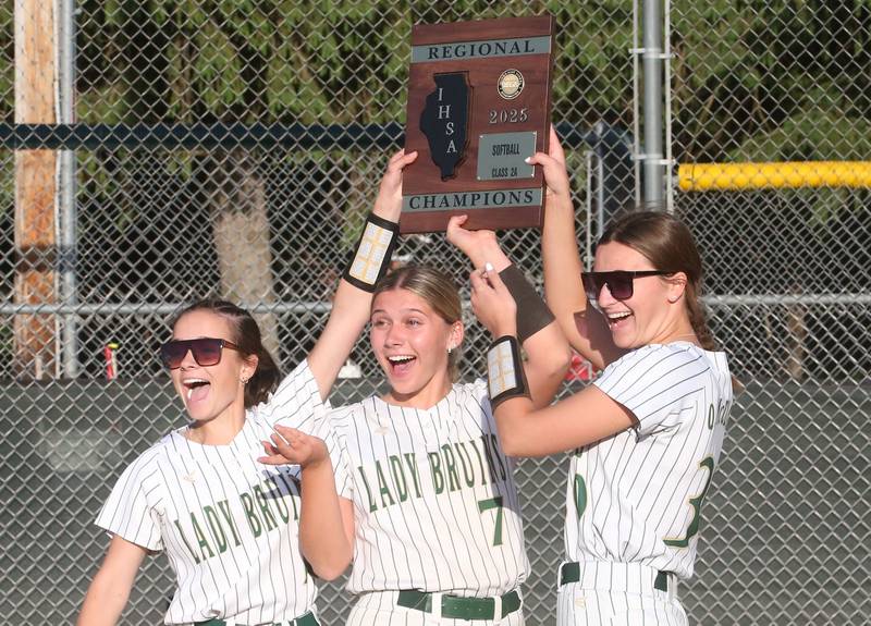 St. Bede seniors Bailey Engels, Maci Kelly and Quin McClain hoist the Class 2A Regional plaque after defeating Illinois Valley Centrall on Friday, May 23, 2025 at St. Bede Academy.