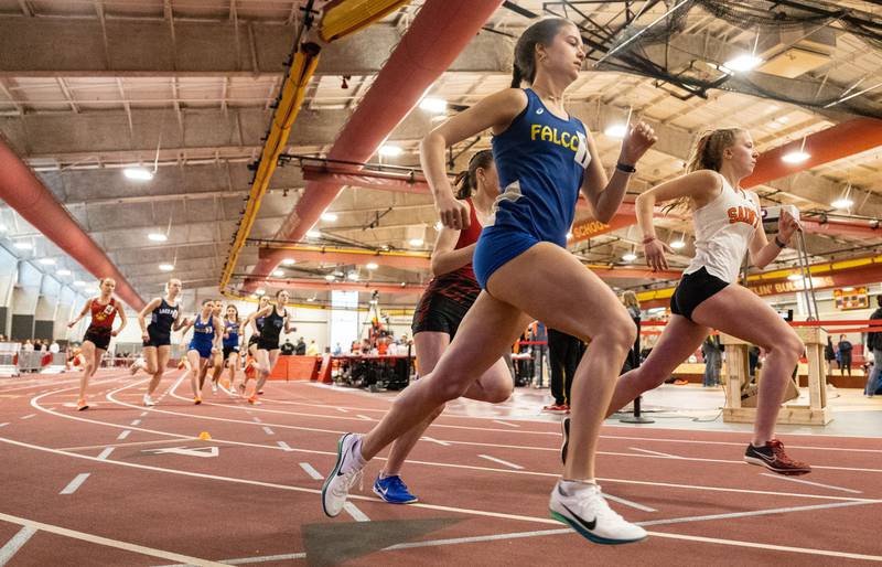 Runners race around the track during the 3200 meter run at the Girls Track and Field DuKane Conference Meet at Batavia High School on Saturday, March 22, 2025.