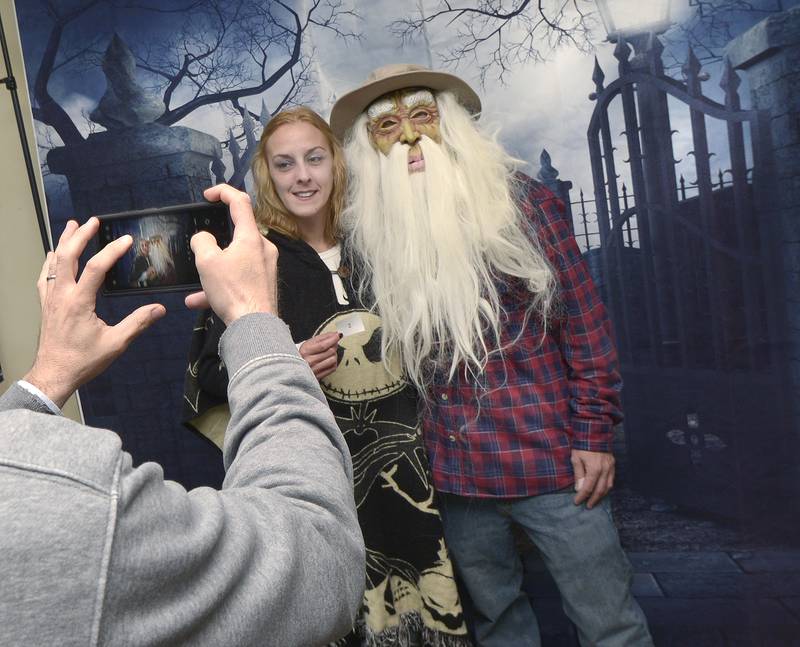 Mindy Soper and Jason Pisker have their photo taken at The Streator Chamber of Commerce as they being their walk to downtown businesses for a scavenger hunt during the Stretor Halloween Spooktacular Friday night.