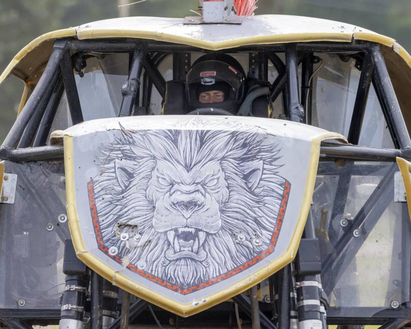 Maximus driver Travis Groth watches a fellow competitor's truck compete while he waits for his turn Saturday, July 20, 2024, during the Overdrive Monster Truck Show at Bureau County Fairgrounds.