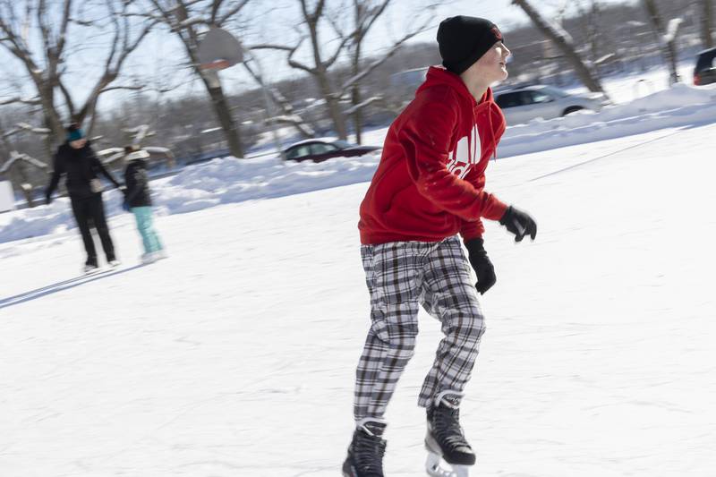 Mason Schaefer, 14, zips around the ice rink in Dixon Saturday, Jan. 20, 2024. Despite the cold, the rink at Page Park was just recently frozen enough for skating. Saturday marked the first day the surface was open.