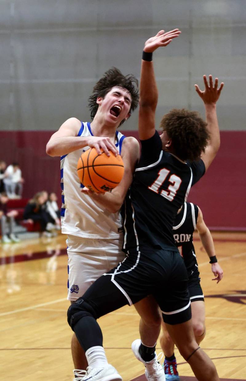 Princeton's Noah LaPorte draws contact from Byron's JJ Edmonson in Wednesday's sectional semifinals at Marengo. Princeton won 46-42 to advance to Friday's championship against Rock Falls.