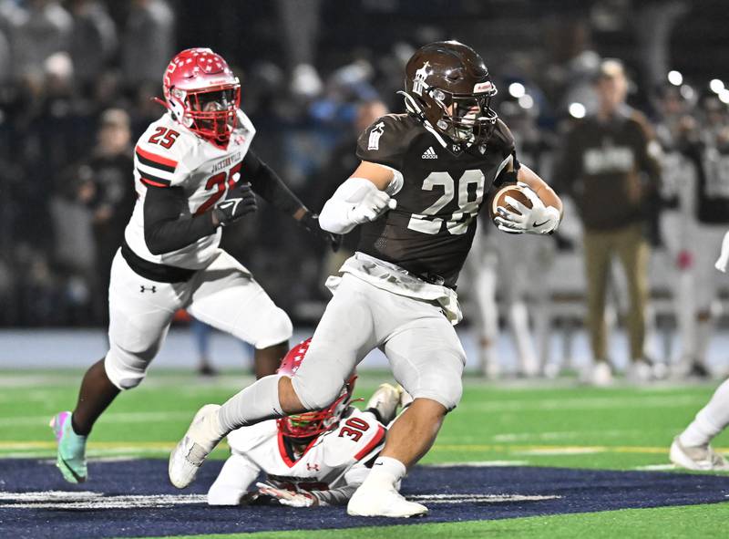 Joliet Catholic's Nate Magrini (28) rushes for a big gain during the IHSA Class 5A first round playoff game against Jacksonville on Saturday, Nov 02, 2024 at Joliet. (Dean Reid for Shaw Local News)