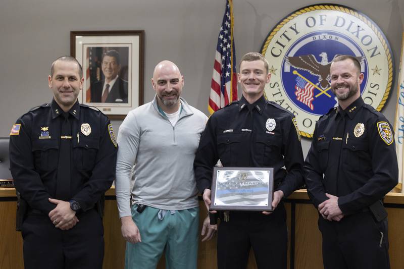 Dixon Police Officer Collin Grady receives a life-saving award Monday, Feb. 2, 2026, for his response to a car accident victim. Pictured are Dixon Deputy Chief Aaron Simonton (from left), Dr. Tyron Brand, Collin Grady and Police Chief Ryan Bivins.