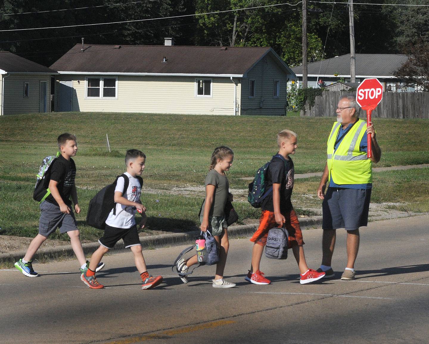 Crossing guard Craig Shimkus assists students across Oakley Avenue on Wednesday, Aug. 17, 2022, as classes begin at Centennial School in Streator.