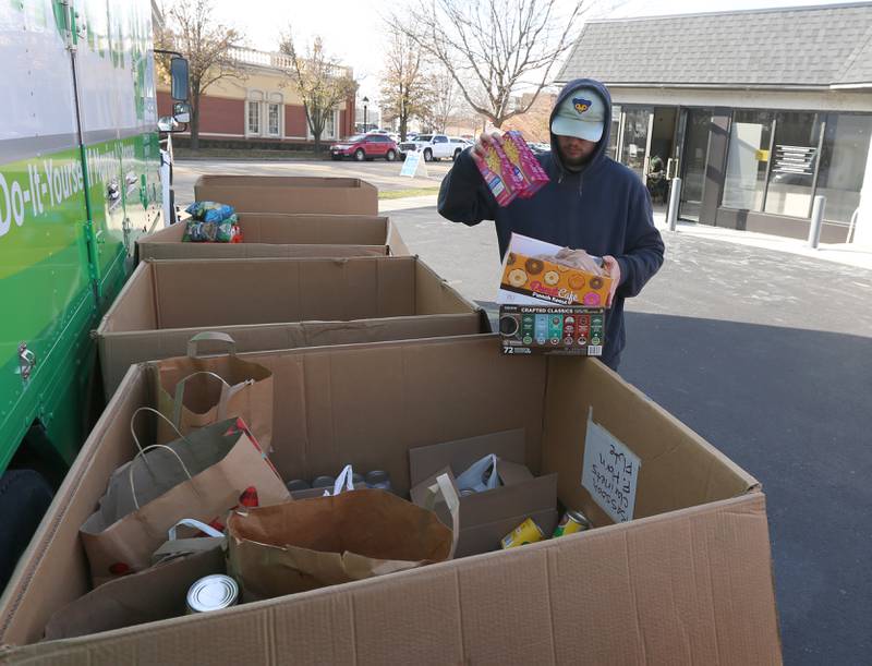 Ethan Christie collects non-perishable food for the Ottawa Community Food Basket during the 14th annual 'Freezin For a Reason' event on Friday, Dec. 2, 2022 in Ottawa.