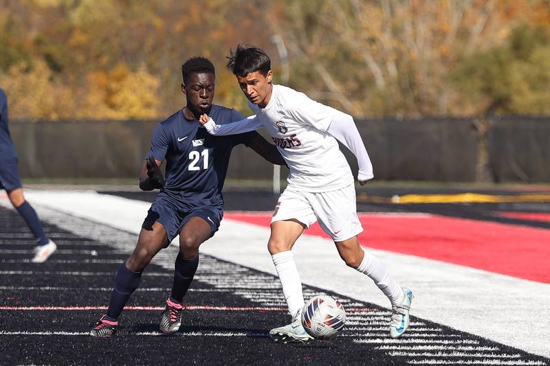 Bolingbrook’s Diego Alarcón works the ball against West Aurora’s Sere Iranloye in the Class 3A Bolingbrook Regional championship match on Saturday, Oct. 26, 2024 in Bolingbrook.