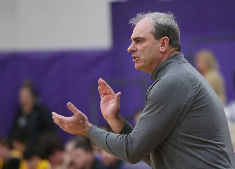 Ottawa boys basketball coach Mark Cooper applauds his team while facing Mendota on Tuesday, Feb. 13, 2024 at Mendota High School. With the win, Cooper passes former head coach Dean Riley for most wins (333) in Ottawa boys basketball program history.