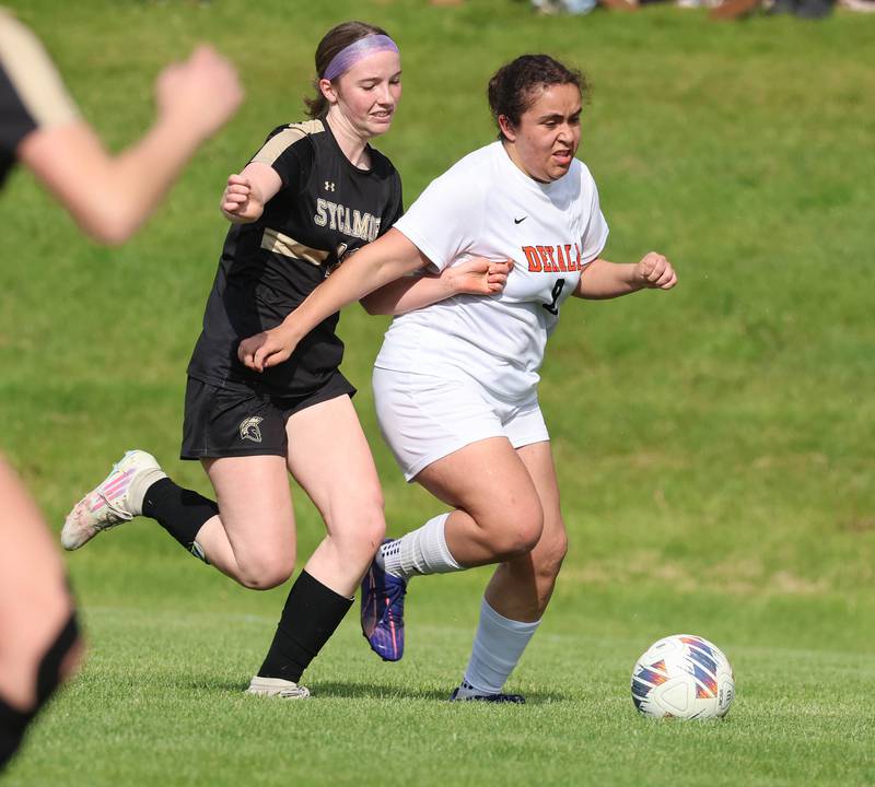 DeKalb's Alexia Ortiz tries to hold off Sycamore's Ellie Lawless Thursday, May 7, 2026, during their game at Sycamore High School.