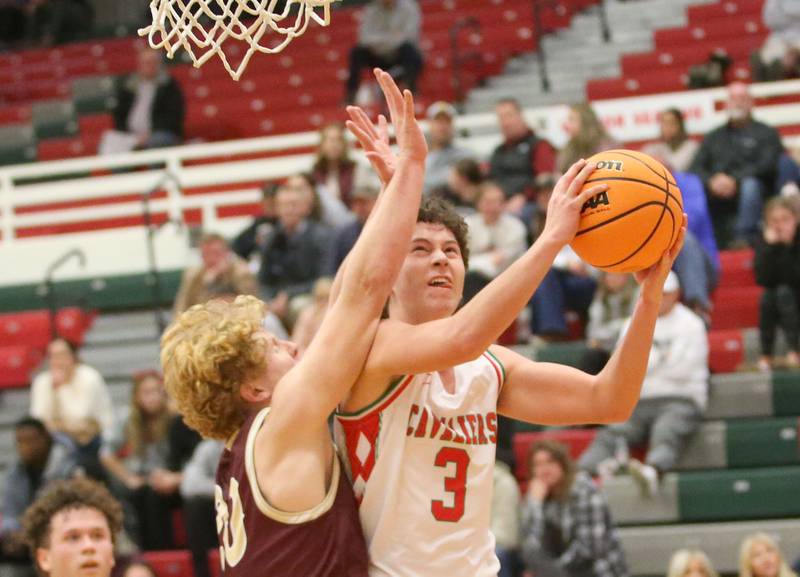 L-P's Mikey Hartman eyes the hoop as Morris's RJ Kennedy defends on Friday, Dec. 6, 2024 in Sellett Gymnasium at L-P High School.