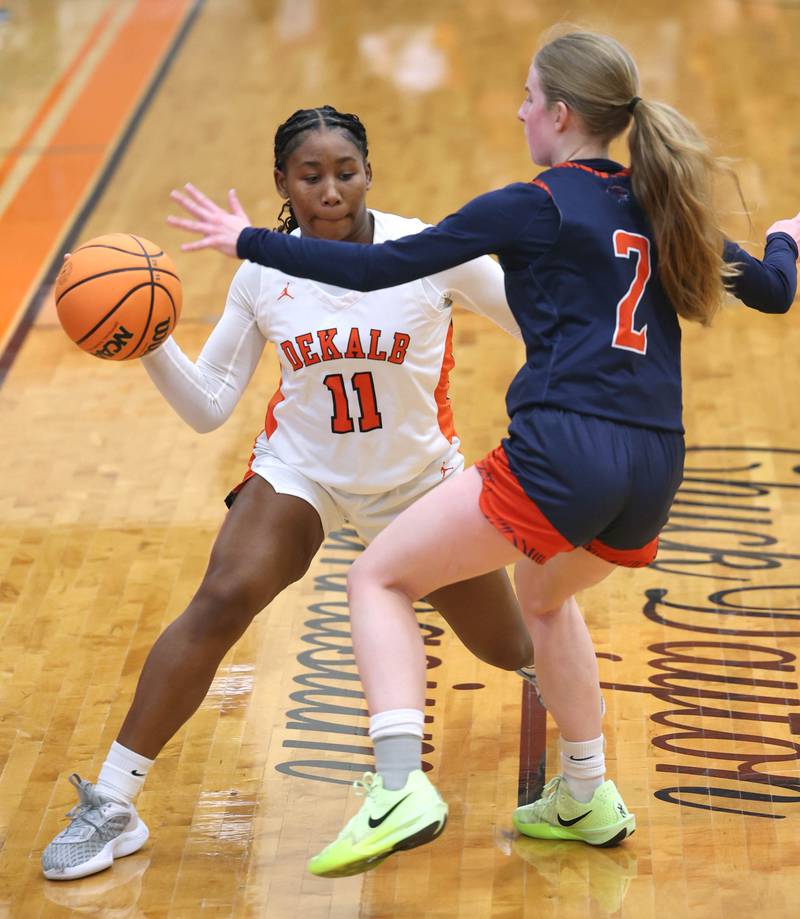 DeKalb's Johnna Patrick passes the ball around Oswego's Ashley Cook during their game Monday, Jan. 5, 2026, at DeKalb High School.