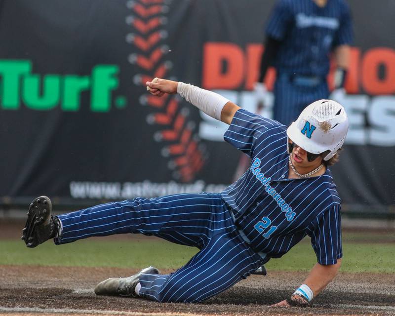 Nazareth's Jaden Fauske (21) slides into home plate during Class 3A Crestwood Supersectional game between Lindblom at Nazareth.  June 5, 2023.