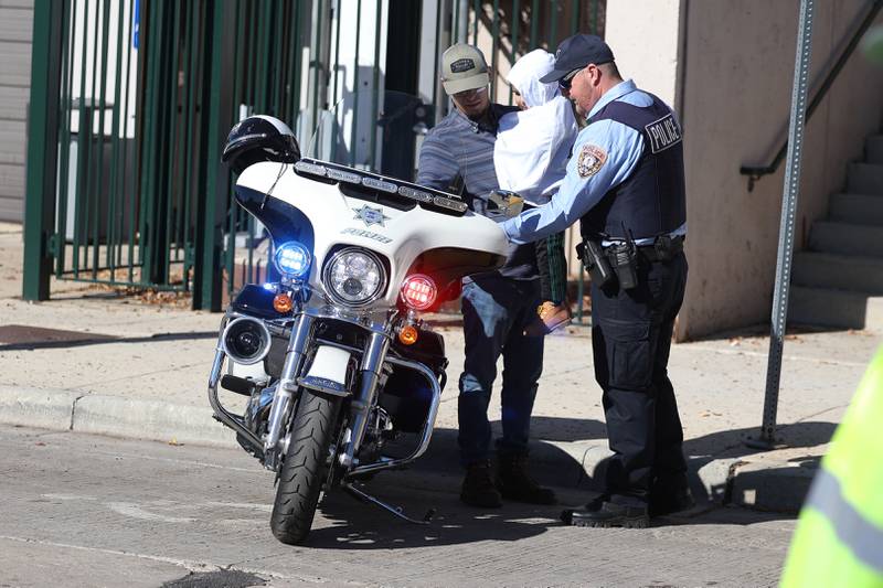 A police officer turns on the siren for a father and daughter at the Joliet Police Department Trunk-Or-Treat event on Saturday, Oct. 26, 2024 in Joliet.