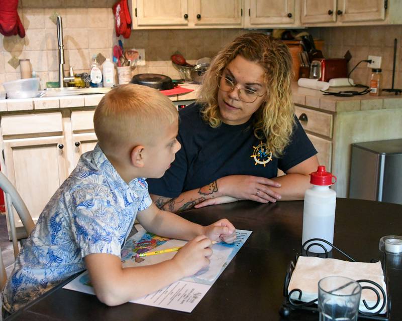 Brooke Christenson talks with her son Malcom, 5, as he learns the shapes of different continents on Friday Oct. 3, 2025, in St Charles Township.