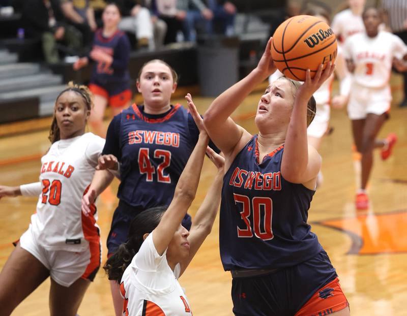Oswego's Peyton Johnson shoots over DeKalb's Nazeria Dean during their game Monday, Jan. 5, 2026, at DeKalb High School.