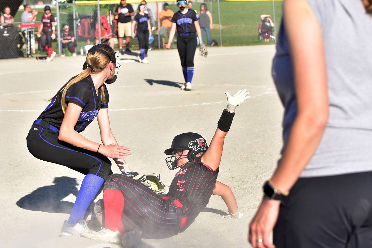 Erie Prophetstown's Jaylynn Hamilton dive back to first base safely beating the tag by Newman's Claire Von Holten during a Tuesday, May 6, 2025 game in Prophetstown. The Panthers outscored the Comets 8-2.