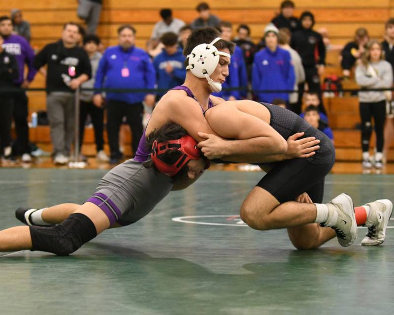 Caden Chiarelli, left, of downers Grove North keeps a hold of Zach Steward of Marmion Academy as Zach took the win during the 138 weight class regional title match on Saturday Feb. 3, 2024, held at Glenbard West high school.