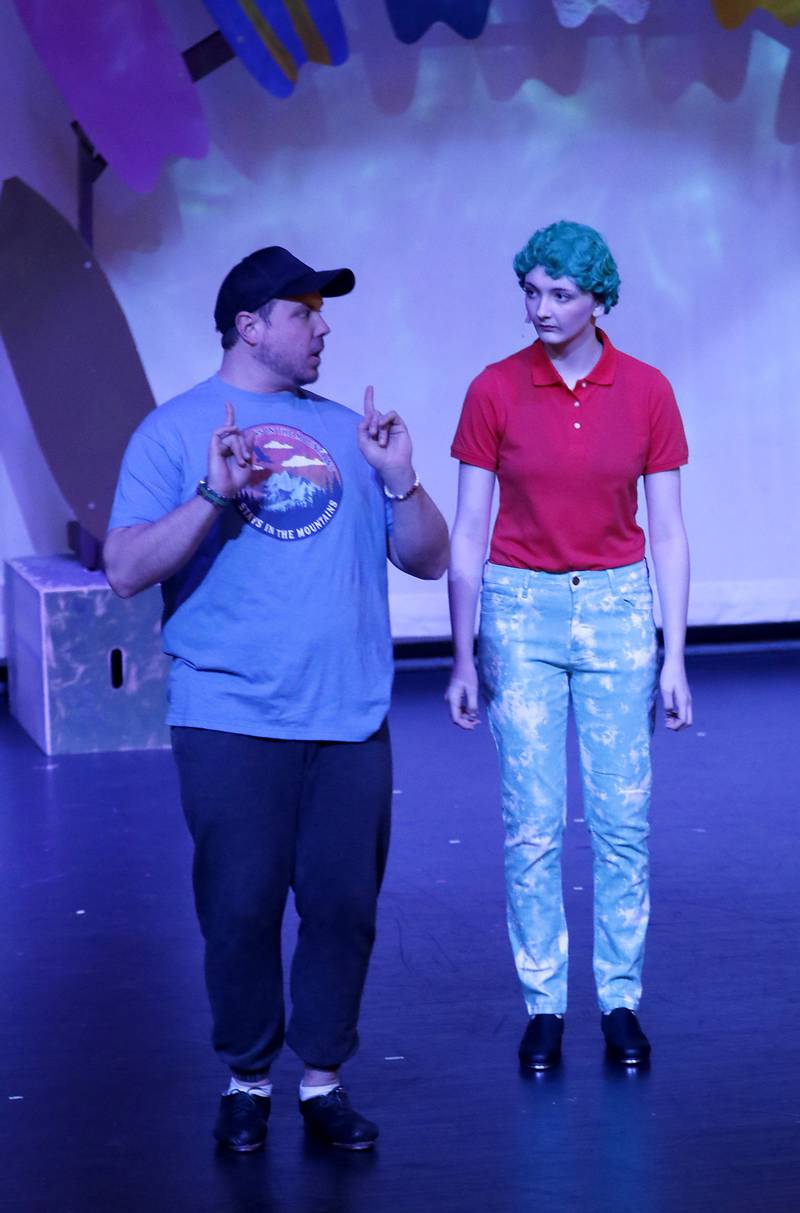 Choreographer Billy Seger works with Hannah Covalt, playing Squidward, on a dance number before the start of a dress rehearsal for the McHenry Community High School’s production of “The SpongeBob Musical” on Tuesday, March 7, 2023, at the school’s Upper Campus.