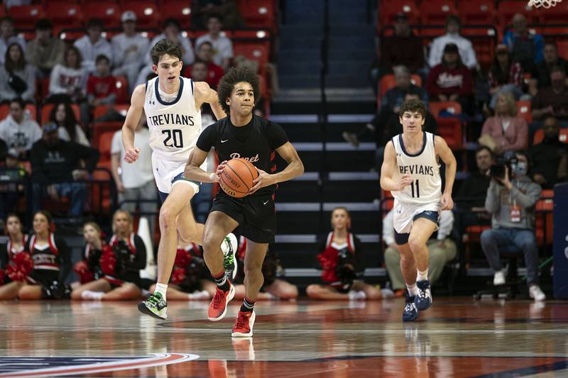 Benet Academy’s Brayden Fagbemi makes a pass against New Trier Friday March 10, 2023 during the 4A IHSA Boys Basketball semifinals.