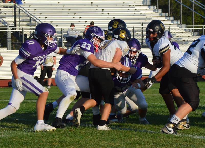 Rochelle's Jace Spears (23) and Andrew Eyster (12) tackle a Sycamore player during their JV football game. Rochelle won 18-6.